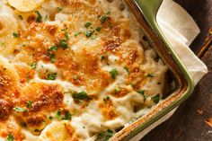 a casserole dish with cheese and parmesan on the side, ready to be eaten