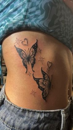 a woman's stomach with two butterflies on it