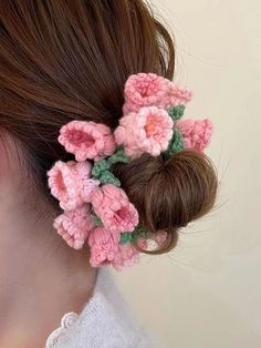 a close up of a woman's hair with crochet flowers in it