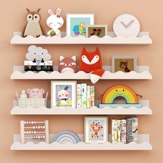 there are many shelves with pictures and stuffed animals on them in the children's room