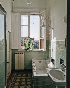 a bath room with a sink a window and a radiator