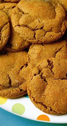 a plate full of cookies sitting on top of a polka dot tablecloth covered table