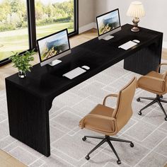 an office desk with two computer screens on it and chairs in front of the desk