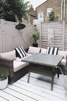 an outdoor patio with furniture and potted plants