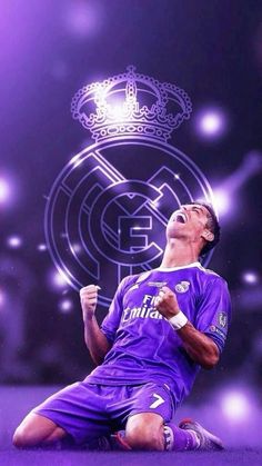 the soccer player is celebrating his team's win in front of an image of real madrid