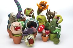 a group of stuffed toy plants with faces and mouths on them, all in pots