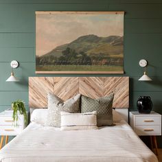 a bedroom with green walls and wooden headboard