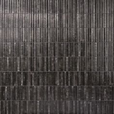 an abstract black and white photo with vertical lines on the wall, as if it were made out of concrete