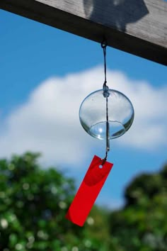 a bird feeder hanging from the side of a wooden structure