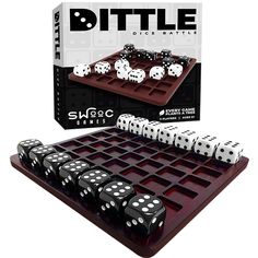 a board game with dices on it in front of a card case and box