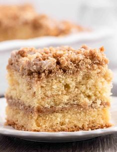 a close up of a piece of cake on a plate with another slice in the background