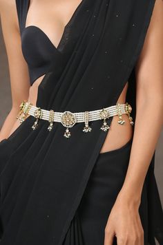 This waist belt is fabricated with several strings of pearls with strewn in kundan encrusted units. The traditional design will amp up the look of your traditional attire. Closure - Lobster Style Tip - This layered waist belt with its cascading elements is simply gorgeous. With a modern twist to the traditional waist belt it makes for an apt piece for the modern day woman in love with her traditional heritage. Pair this with your Banarsi sarees and lehengas to accentuate the glamour of your outf Waist Belt For Saree, Golden Belt For Saree, Pearl Waist Belt, Hip Belt For Saree Gold, Pearl Kamarbandh, Moti Kamar Belt, Waist Belt Gold Indian Jewellery, Waist Chain Indian, Golden Kamarbandh