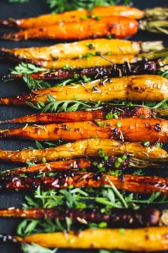 grilled carrots with herbs and seasoning on a baking sheet, ready to be served