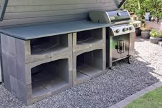 an outdoor bbq grill with two large storage bins