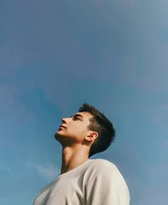 a man looking up into the sky with his eyes closed