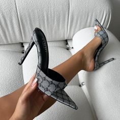 Feel fresh in these grey monogram heeled mules! Featuring a pointed toe, front strap, and a stiletto heel. Style these grey monogram heeled mules with a mini dress and statement accessories. - Heel measures approximately 4.25 inches/ 10.8cm- Faux leather upper- Model wears UK 6 / EU 39 / US 8- Fits true to size Elegant Gray Spring Heels, Gray Summer Party Heels, Gray Heels For Summer Evenings, Gray Heels For Spring Party, Chic Fitted Gray Heels, Gray Party Heels For Spring, Chic Gray Pointed Toe Heels, Chic Gray Heels For Spring, Gray Fitted Heels For Evening