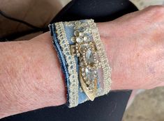 a close up of a person's arm wearing bracelets