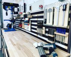 tools are lined up on the wall in a shop