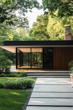 the modern house is surrounded by trees and grass