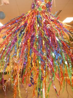 a large multicolored chandelier hanging from the ceiling in an office building