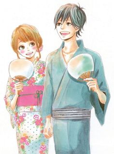 a man and woman in kimonos holding fan shaped mirrors