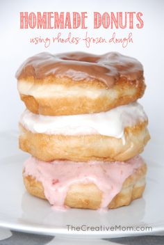 three donuts stacked on top of each other with frosting and pink icing