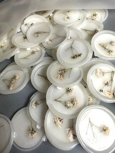 many white plates with dried flowers on them