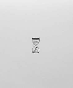 an hourglass sitting on top of a white surface