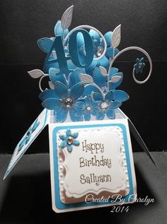 a blue and white birthday card with flowers