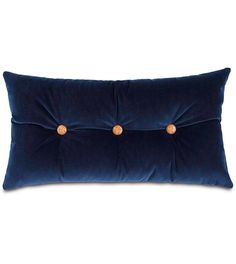 a blue velvet pillow with wooden buttons on it's back and the front is turned down