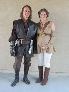 a man and woman dressed up as star wars characters standing next to each other in front of a wall