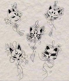 four masks with flowers on them and one has a cat's head in the middle