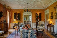 a living room filled with furniture and paintings