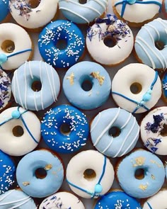 many blue and white donuts with sprinkles on them