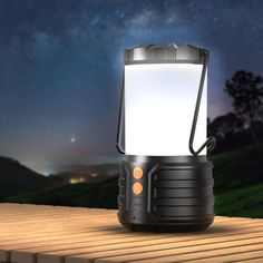 an outdoor lantern is lit up on a wooden platform with the night sky in the background