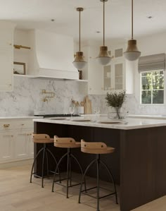 two stools are in front of the kitchen island