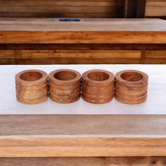 four wooden rings sitting on top of a table