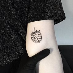 a person with a small tattoo on their arm