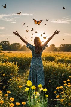 a woman standing in a field with her arms outstretched and butterflies flying over her head