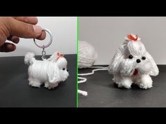 there is a small white dog keychain on the table