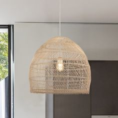 a light that is hanging from the ceiling in a room with some chairs and a table