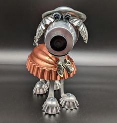 a silver and copper dog figurine sitting on top of a black countertop