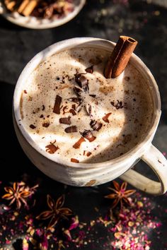 an overhead view of a cup of coffee with cinnamon and star anise