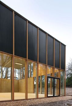 the side of a building with glass windows and wood trimmings on it's sides