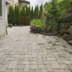 a brick walkway in front of a house