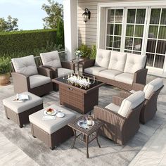 an outdoor living room with wicker furniture