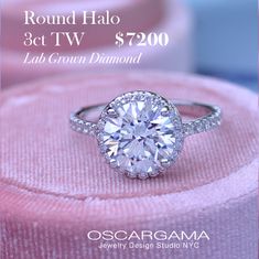 a round diamond ring on top of a pink velvet cushion with the words, round halo 3ct tw $ 7200 lab grown diamond