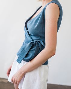 "Fitted, aesthetic, and very elegant sleeveless linen wrap top made from Lithuanian washed linen fabric. Comes with a belt to tie on the side for an effortless but well put together look. FABRIC: 100% Washed Lithuanian Linen COLOR: Please choose the desired color from the side menu. STYLE: Fitted linen sleeveless wrap top with a belt tied on the side. SIZE CHART: 2 US/ 6 AU/ 34 EU: Bust 31.5\" (80 cm) , Waist 23\" (59 cm), Hips 35\" (88 cm) 4 US/ 8 AU/ 36 EU: Bust 33\" (84 cm) , Waist 25\" (63,5 Blue Linen V-neck Blouse, Cotton Wrap Top For Summer, Summer Cotton V-neck Wrap Top, Casual Linen Wrap Top, Casual Linen Wrap Top For Summer, Chic Cotton Wrap Top For Summer, Fitted Sleeveless Wrap Top For Spring, Fitted Sleeveless Wrap Top Casual, Casual Cotton Wrap Top