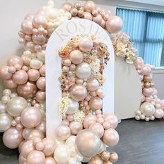 an arch made out of balloons and flowers