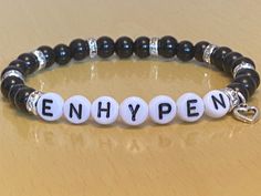 "⚠️Warning ⚠️ WE DO NOT SHIP TO GERMANY! Hi welcome to our new mini business!! What we are selling here is a classy Enhypen/Engene bracelet.  These are some of the best features about our product: Bead Type: Glass Pearl (size- 6mm) 9 Crystal Spacers  1 Open Heart Charm Alphabet beads  Strong Elastic Has Bead Glue for extra safety Packaging: Free NON official photocard with pouch  Free mini disk with group name on organza bags  The inspiration behind this product came from having a lot of kpop friends all around the world and I wanted to gift them something special for christmas. My mum used to make bracelets back in the day and I came up with an idea to hand-make my friends bracelets with my mums help. I found out by doing this activity that I really enjoyed the progress of making them. Ma Bracelets For Friend Groups, Enhypen Bracelet Ideas, Enhypen Bracelet, Kpop Enhypen, Mini Business, Alphabet Beads, Friend Bracelets, Band Bracelet, Open Heart